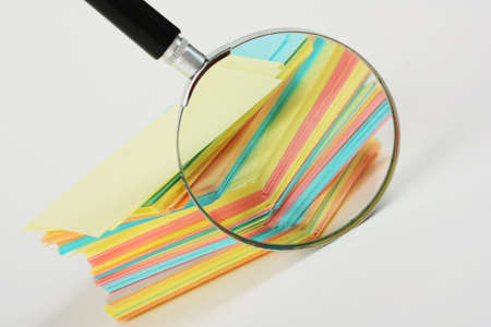 Magnifier enlarges the stack of sheets of paper