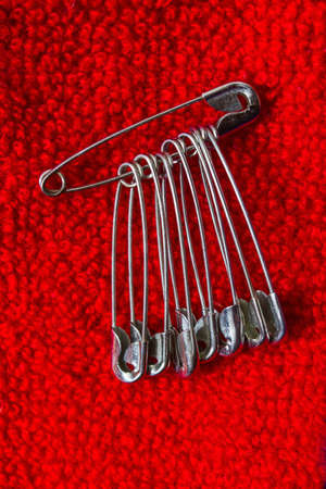 Safety pin pinned to the texture color fabricの写真素材