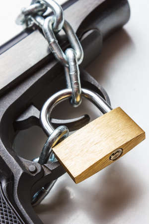 the gun coiled chain closed by a padlockの写真素材