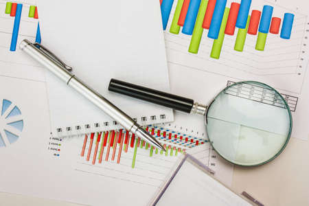 Graphs tables and documents laid on the table
