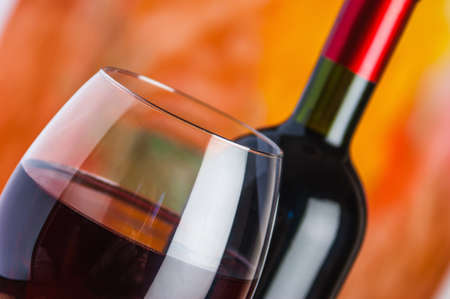 Wine, glass and the bottle on a colored backgroundの写真素材