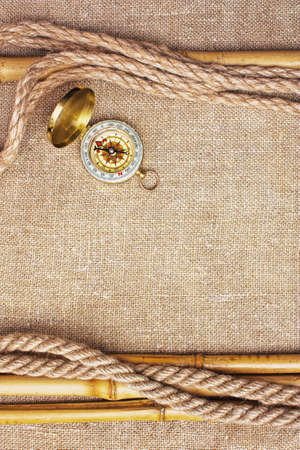 Compass with a rope on the background of the old patternの写真素材