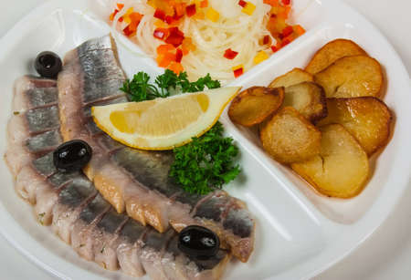 Marinated herring with potatoes isolated on a white backgroundの写真素材