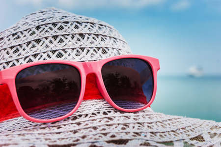 Concept of summer with straw hat and sunglassesの写真素材