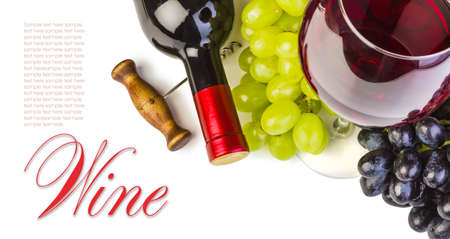 glass of red wine with bottle and grapes on a white backgroundの写真素材