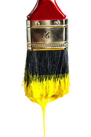paintbrush with yellow paint isolated on white backgroundの写真素材