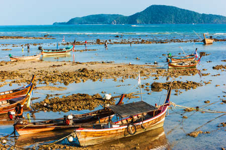 Fishing boats on the sea shore in Phuket, Thailandの写真素材