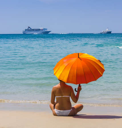 girl with orange umbrella on the beach. Phuket island, Thailandの写真素材