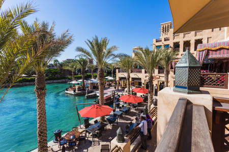 DUBAI - NOVEMBER 7: The famous hotel and tourist district of Madinat Jumeirah NOVEMBER 7, 2013 in Dubai. Built with ancient style, has many shops, restaurants and viewing platforms on Burzh al Arabのeditorial素材