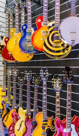 many guitars presented  in a music store