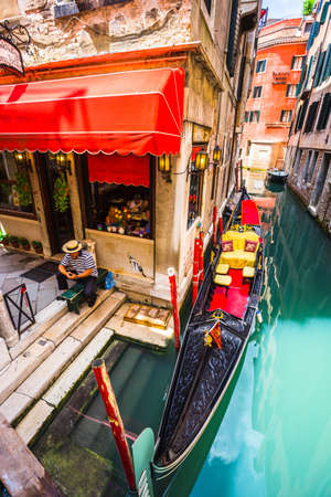 VENICE, ITALY - JUNE 26: Tourists travel on gondolas at canal on June 26, 2014 in Venice, Italy . Gondola trip is the most popular touristic activity in Venice.のeditorial素材