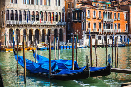 VENICE, ITALY - JUNE 26: Tourists travel on gondolas at canal on June 26, 2014 in Venice, Italy . Gondola trip is the most popular touristic activity in Venice.のeditorial素材