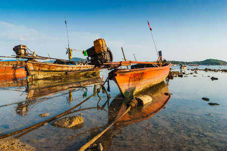 Fishing boats on the sea shore in Phuket, Thailandの写真素材