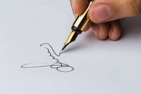 Signature of a fountain pen on white paperの写真素材