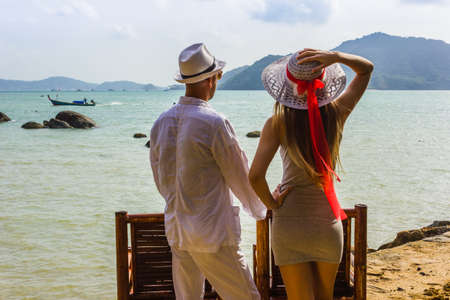 The guy and the girl in the lounge chairs on the background of marine speciesの写真素材
