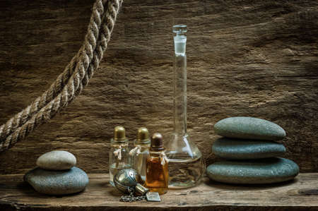 Vials with essential oils against the old wooden wallsの写真素材
