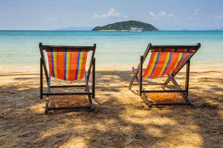 sun beach chairs on shore near sea. Thailandの写真素材