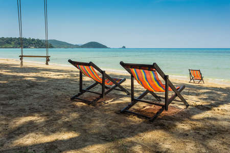 sun beach chairs on shore near sea. Thailandの写真素材