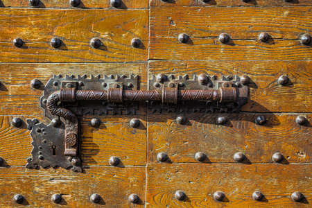 Old italian wooden door with metal knockerの写真素材