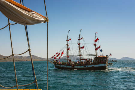 Old ship with sails, sailing in the seaの写真素材