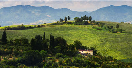 rural landscape with houses standing alone in the province of Tuscany in Italyのeditorial素材