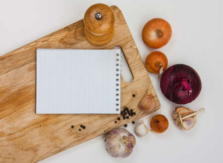notebook for culinary notes on a cutting boardの写真素材