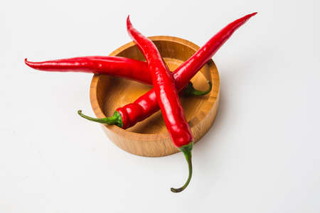 Red chili peppers on a white backgroundの写真素材