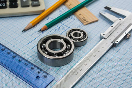 calipers, bearing and square on the background of graph paperの写真素材