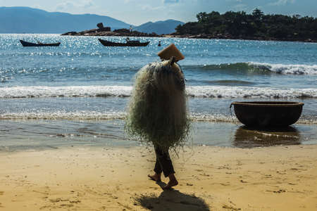 NHA TRANG, VIETNAM - NOV 28: Unidentified fishermen is working on the beach in Nha Trang, Vietnam. On Nov 28, 2014.のeditorial素材