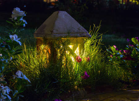 Small ceramic Garden Lamp on surrounded grass fieldの写真素材