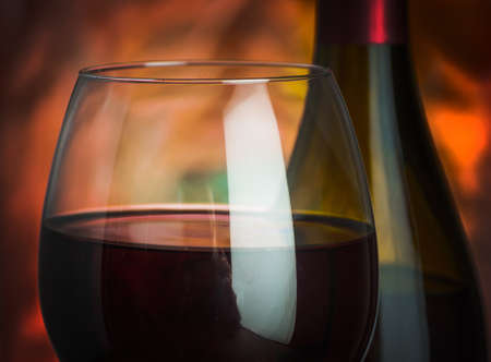 Wine, glass and the bottle on a colored backgroundの写真素材