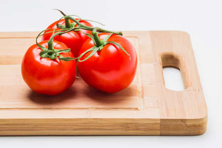 tomatoes and tomato juice on a wooden tableの写真素材