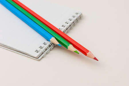 Pencils and notepad isolated on white backgroundの写真素材