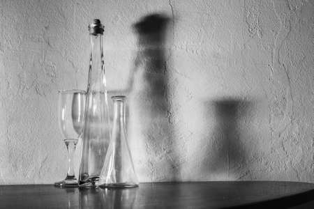 shadow on the white wall of the bottle and wine glassの写真素材