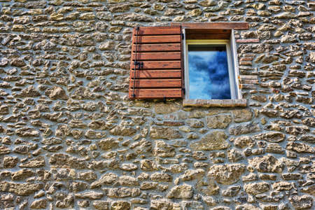 italian window on the building with an stone wall