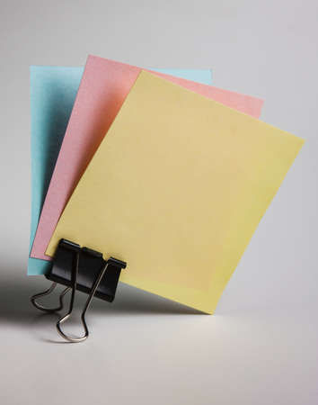 Paper notes on a stand on white background
