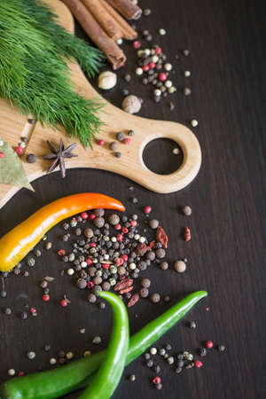 Herbs and spices over black stone background. Top view with copy space