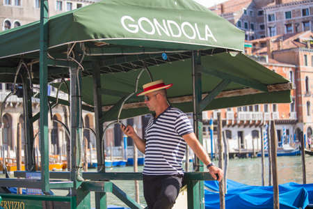 VENICE, ITALY - JUNE 26: Tourists travel on gondolas at canal on June 26, 2014 in Venice, Italy . Gondola trip is the most popular touristic activity in Venice.のeditorial素材
