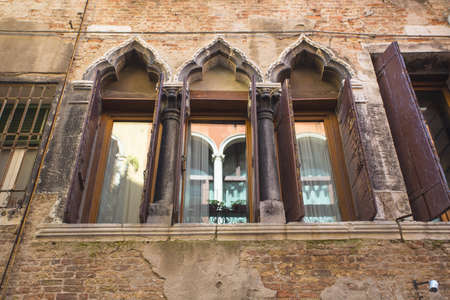 italian window on the building with an stone wallの写真素材