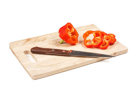 paprika with a knife on a cutting board isolated on a white backgroundの写真素材