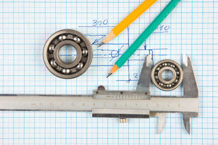 calipers, bearing and square on the background of graph paperの写真素材