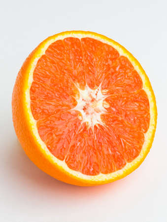 Red orange cut in half on white backgroundの写真素材