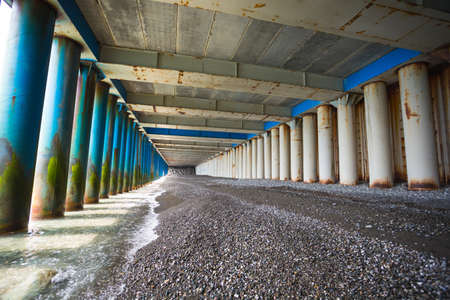 Under the old rusty bridge on the sea shore