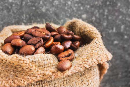 Coffee beans spilled out of the bagの写真素材