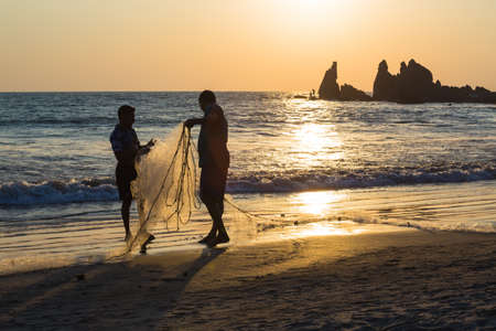 Fishermen on a sunset background in western India. Goaの写真素材