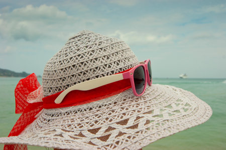 Concept of summer with straw hat and sunglassesの写真素材