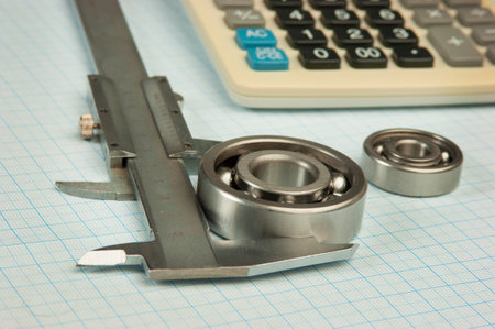 calipers, bearing and square on the background of graph paperの写真素材