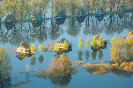 Natural landscape with river, fields and trees at sunsetの写真素材