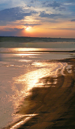 Natural landscape with river, fields and trees at sunset