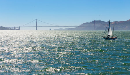 Yacht in San Pablo Bay near San Francisco and Alcatraz Island with the Golden Gate Bridge in the...